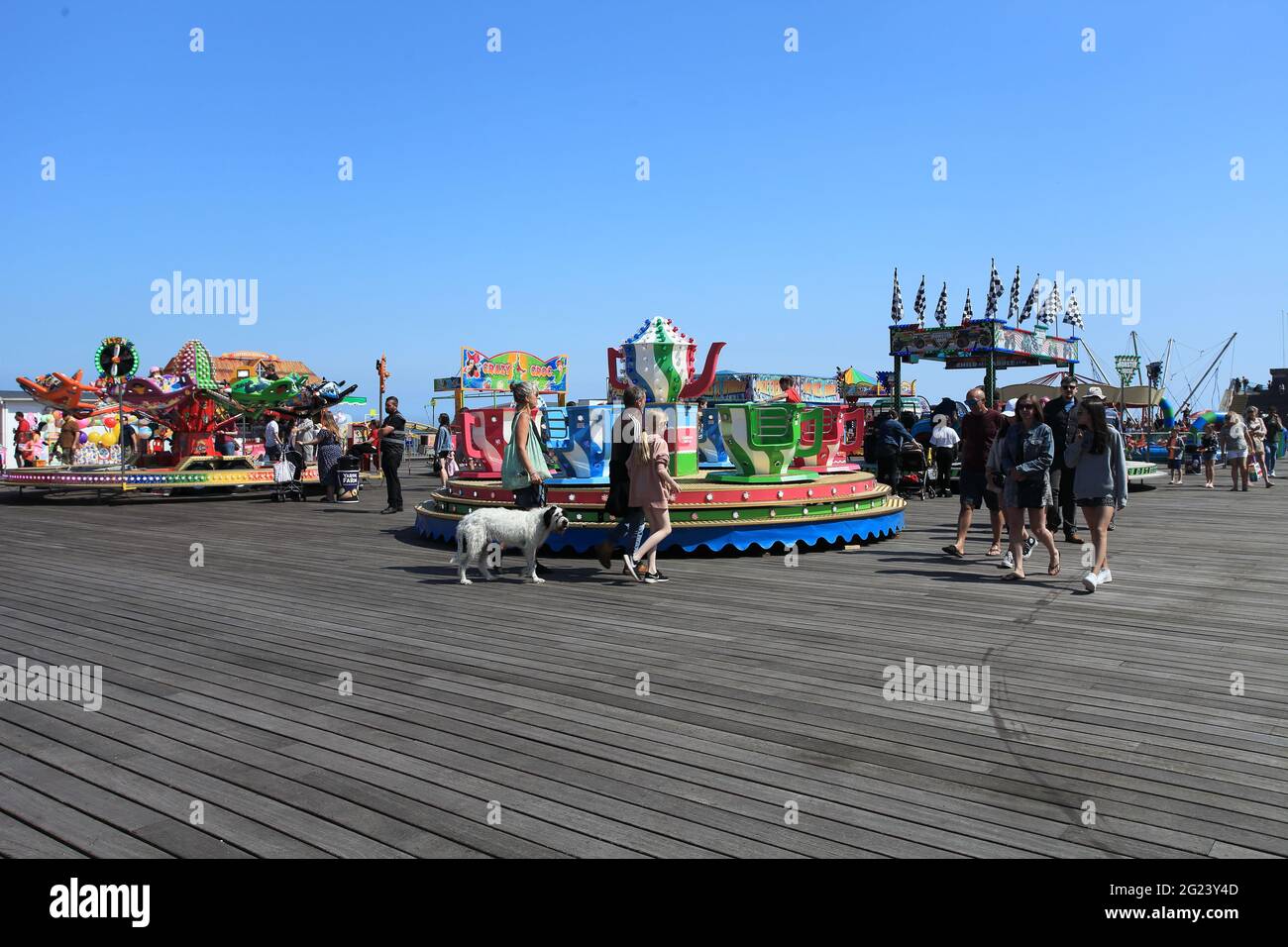 People enjoying a sunny day on Hastings Pier, Hastings, East Sussex, UK Stock Photo