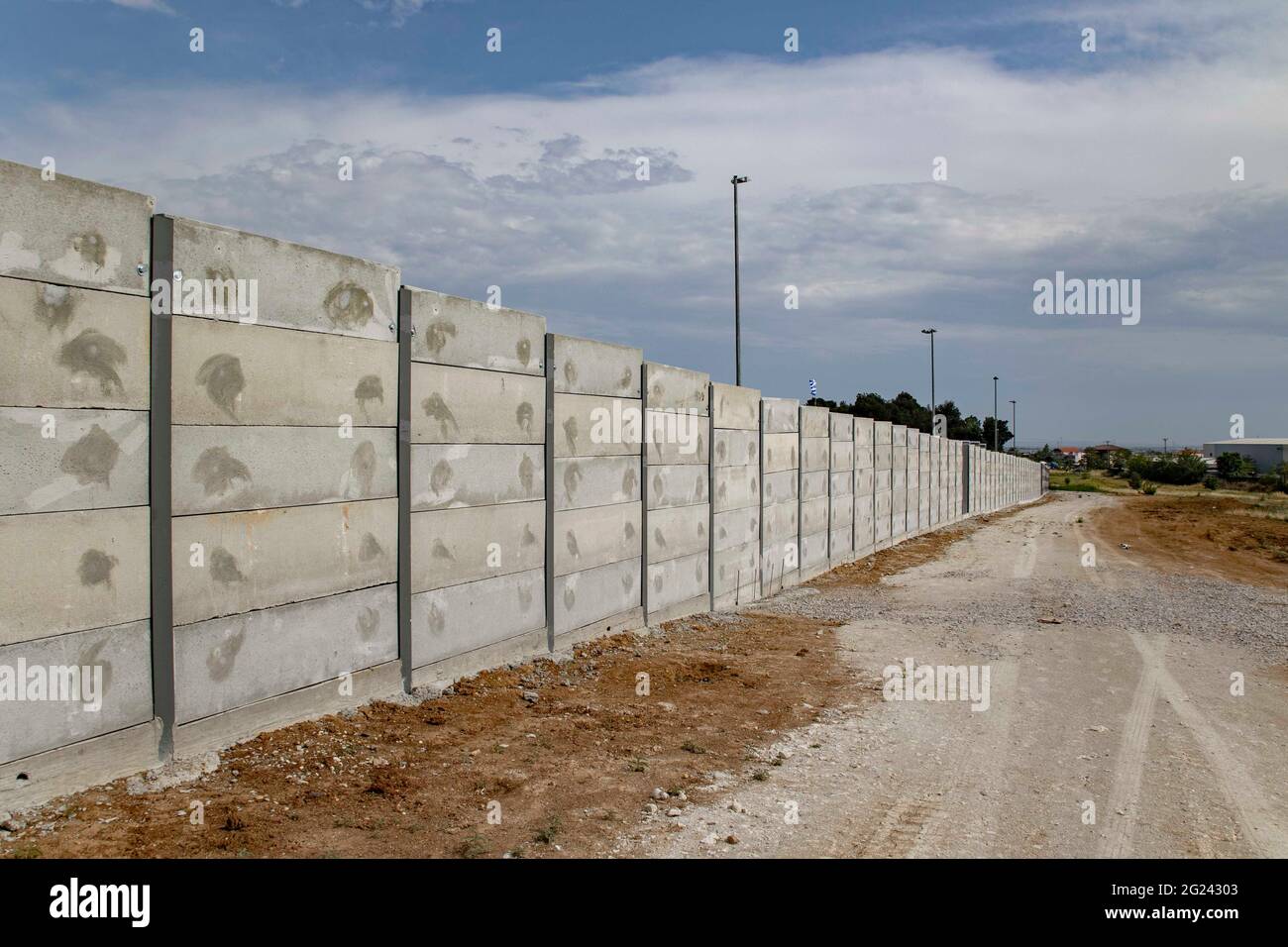 Thessaloniki, Greece. 07th June, 2021. View of a 3-meter grey wall constructed around the Diavata refugee camp near Thessaloniki.High concrete walls are being built around refugee camps on the Greek mainland and the Greek islands, a move Greece claims is for security purposes. Credit: SOPA Images Limited/Alamy Live News Stock Photo