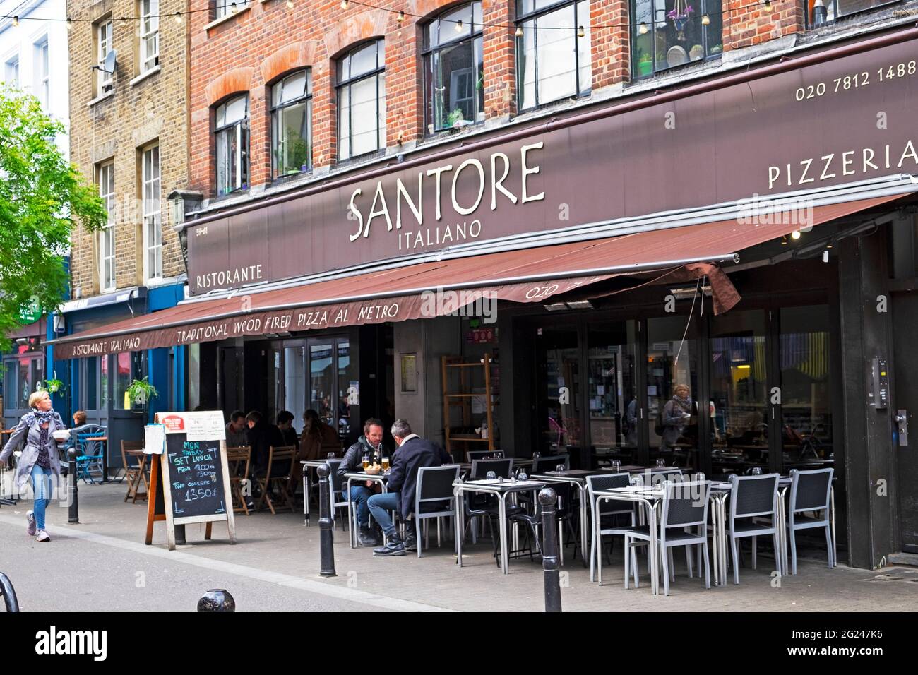 Santore Italian restaurant and pizzeria exterior people sitting at tables outside in Exmouth Market street Clerkenwell London England UK  KATHY DEWITT Stock Photo