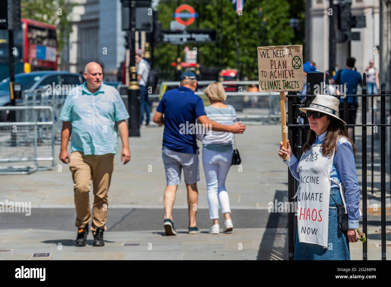 London, UK. 8th June, 2021. We need a plan - A solitary Extinction Rebellion climate protester outside Parliament. As a man rants into his phone about government crooks. Credit: Guy Bell/Alamy Live News Stock Photo