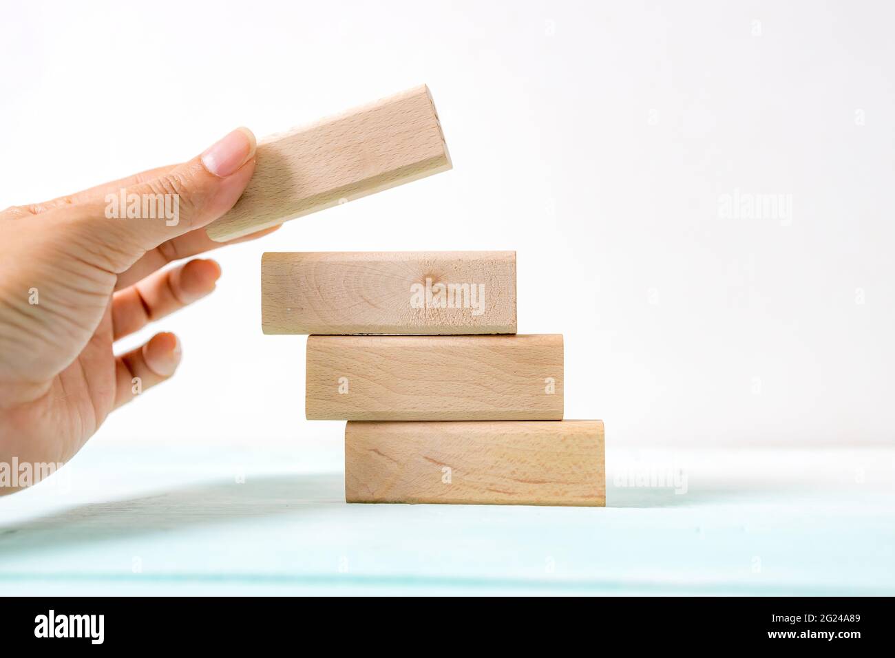 Hand arranging wood block stacking as step stair. Business concept for ...