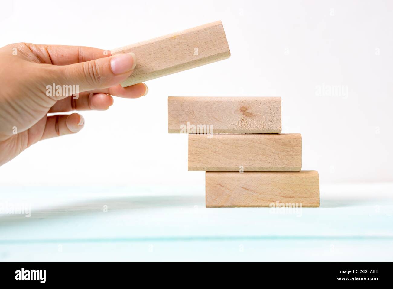 Hand arranging wood block stacking as step stair. Business concept for ...
