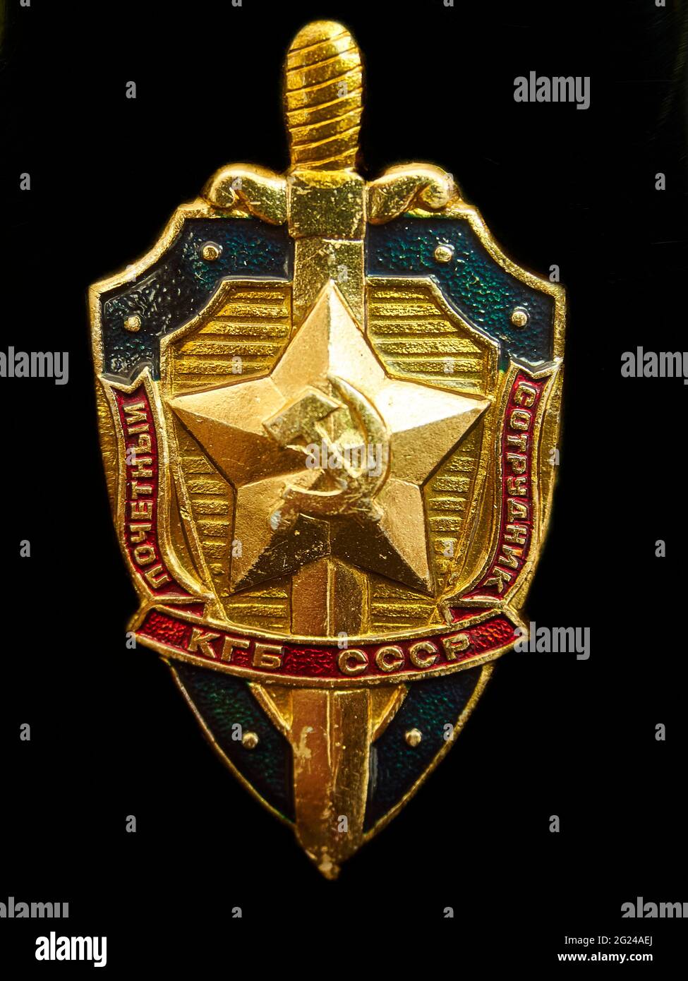 Pictorial, representative image of the badge / insignia of the KGB security agency, attached to a metal flask (photographer’s own) - black background. Stock Photo