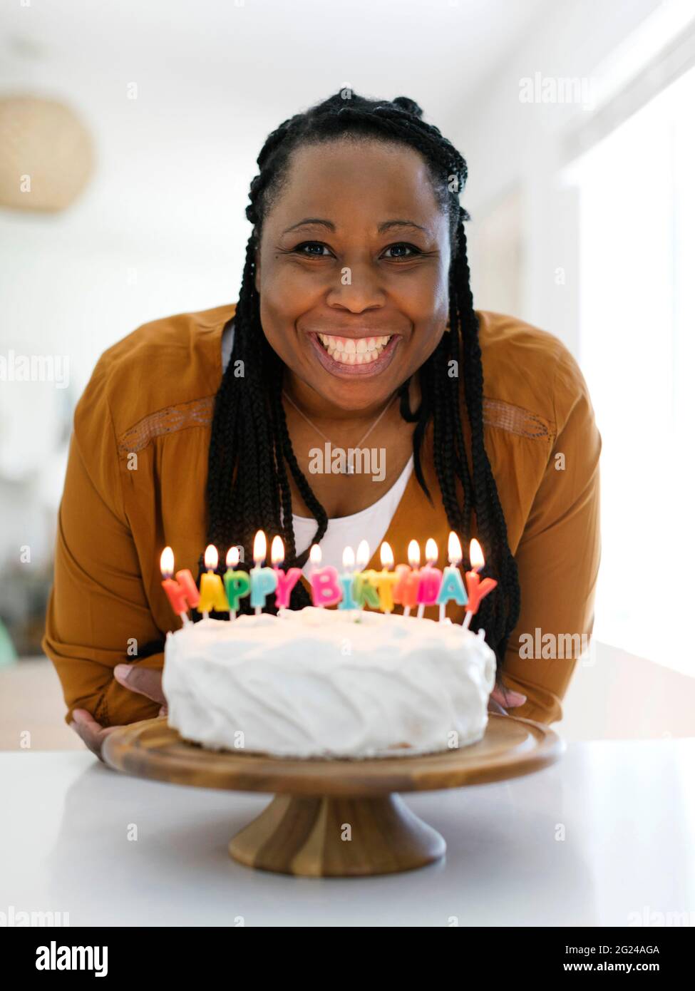 Smiling woman with birthday cake Stock Photo - Alamy