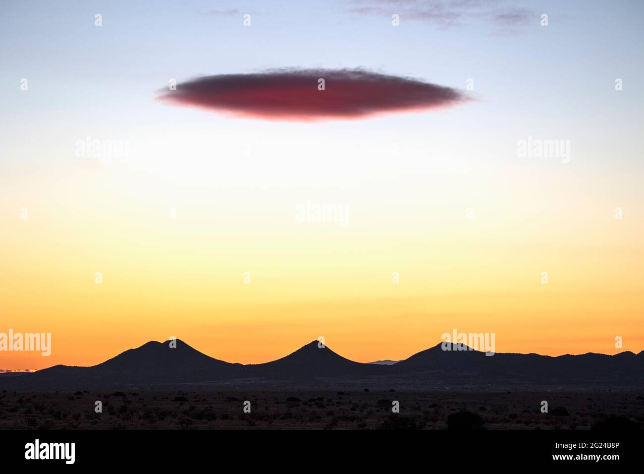 LENTICULAR  CLOUD OVER THE CERRILLOS HILLS, FROM GALISTEO PRESERVE, LAMY, NEW MEXICO, USA Stock Photo