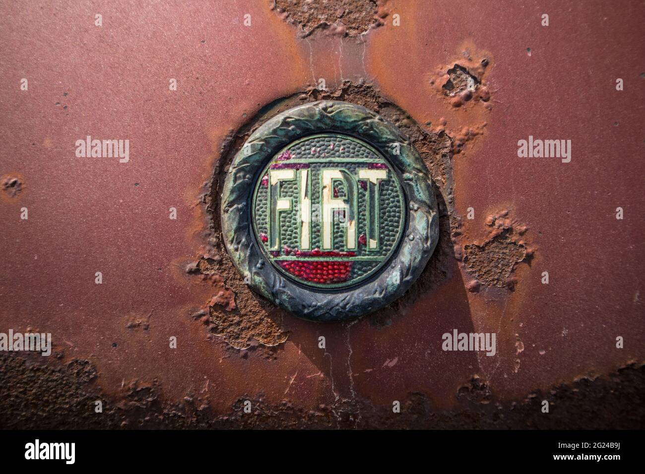 Fiat logo on a rust wrecked car. Stock Photo