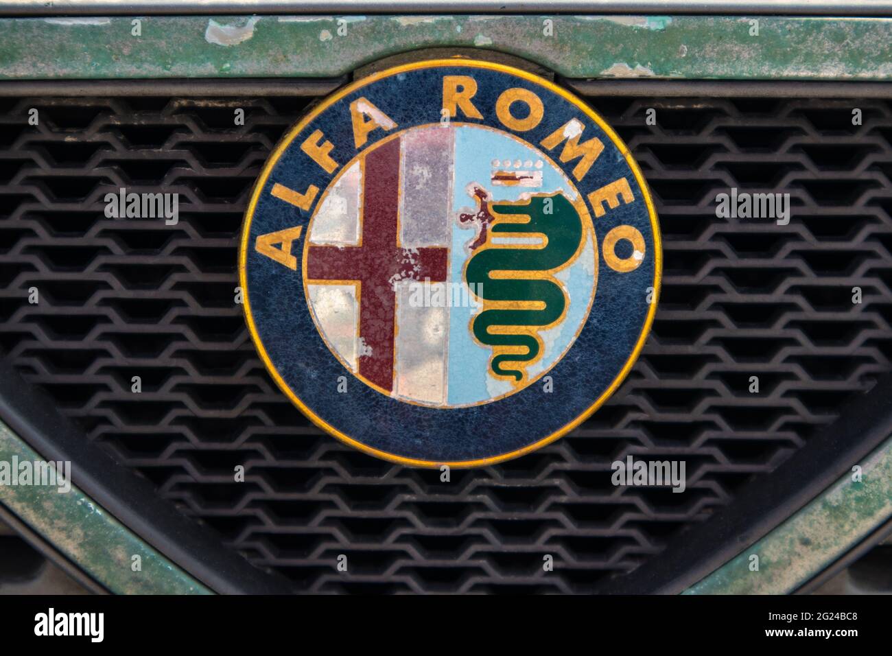 The Alfa Romeo logo on an old rusty fender. Stock Photo