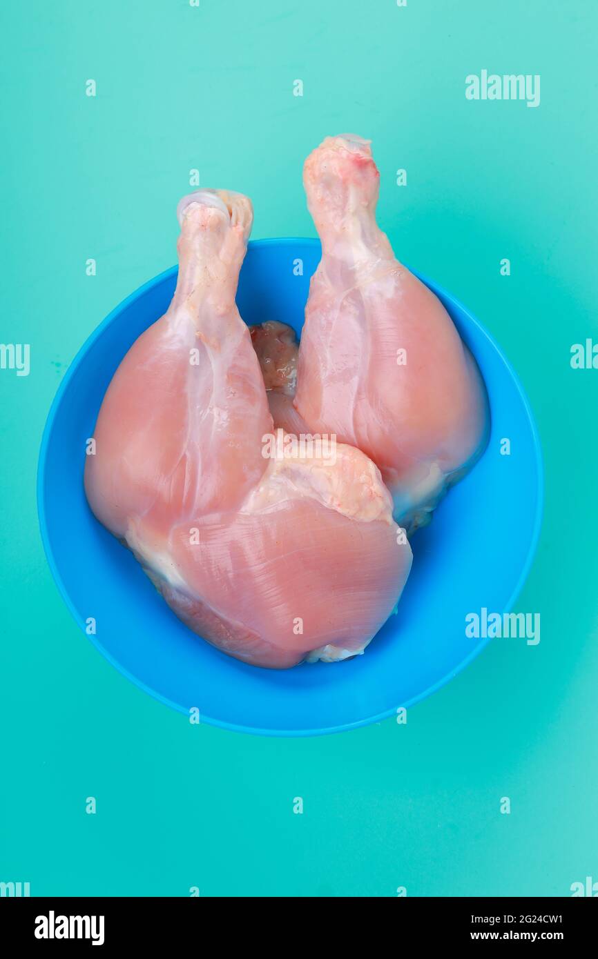 Raw whole chicken with fresh herbs and peas on black stone background, top  view. Culinary white meat eating. Organic chicken Stock Photo - Alamy