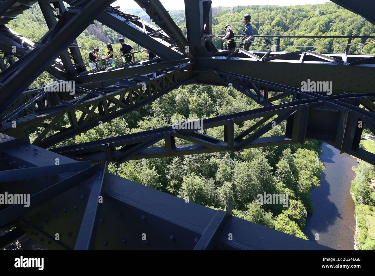 Solingen, Germany. 02nd June, 2021. Secured by harnesses and protected by a helmet, climbers are on their way in the steel scaffolding of the Müngsten Bridge. From August, it will be possible to make the steep ascent in the airy steel construction up to a viewing platform at a height of around 100 metres. Credit: David Young/dpa/Alamy Live News Stock Photo