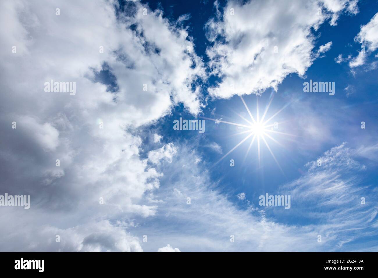 Sun flare in blue sky with clouds Stock Photo - Alamy