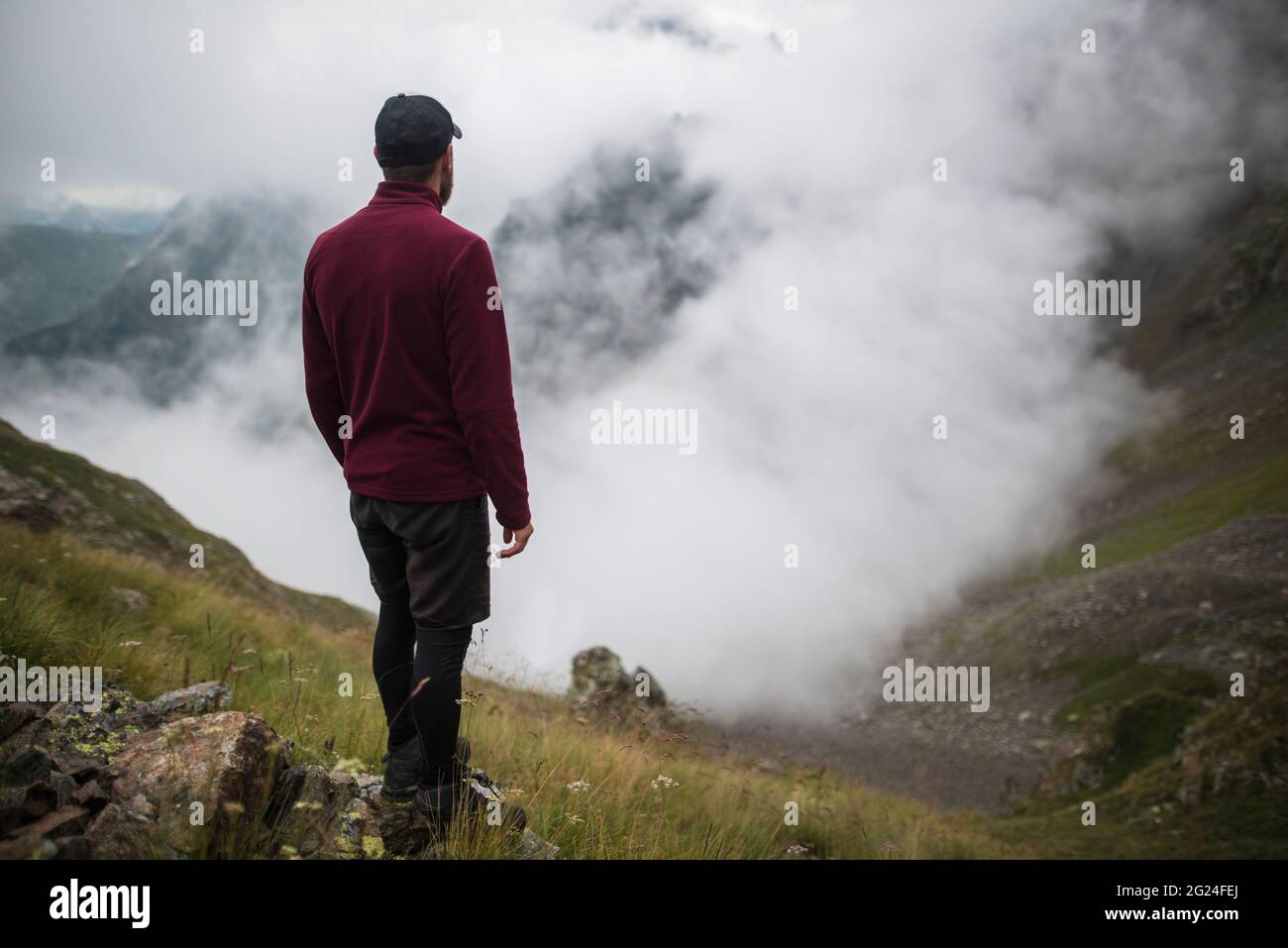 Switzerland, Appenzell, Man hiking in Swiss Alps Stock Photo