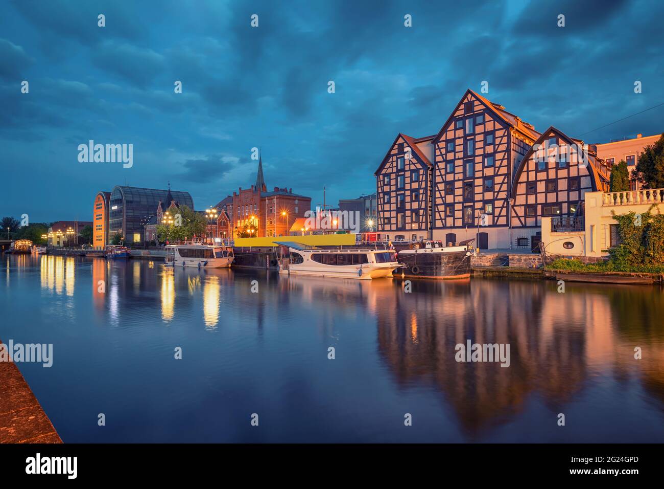 Bydgoszcz, Poland. View of old half-timbered buildings on embankment of Brda river at dusk Stock Photo