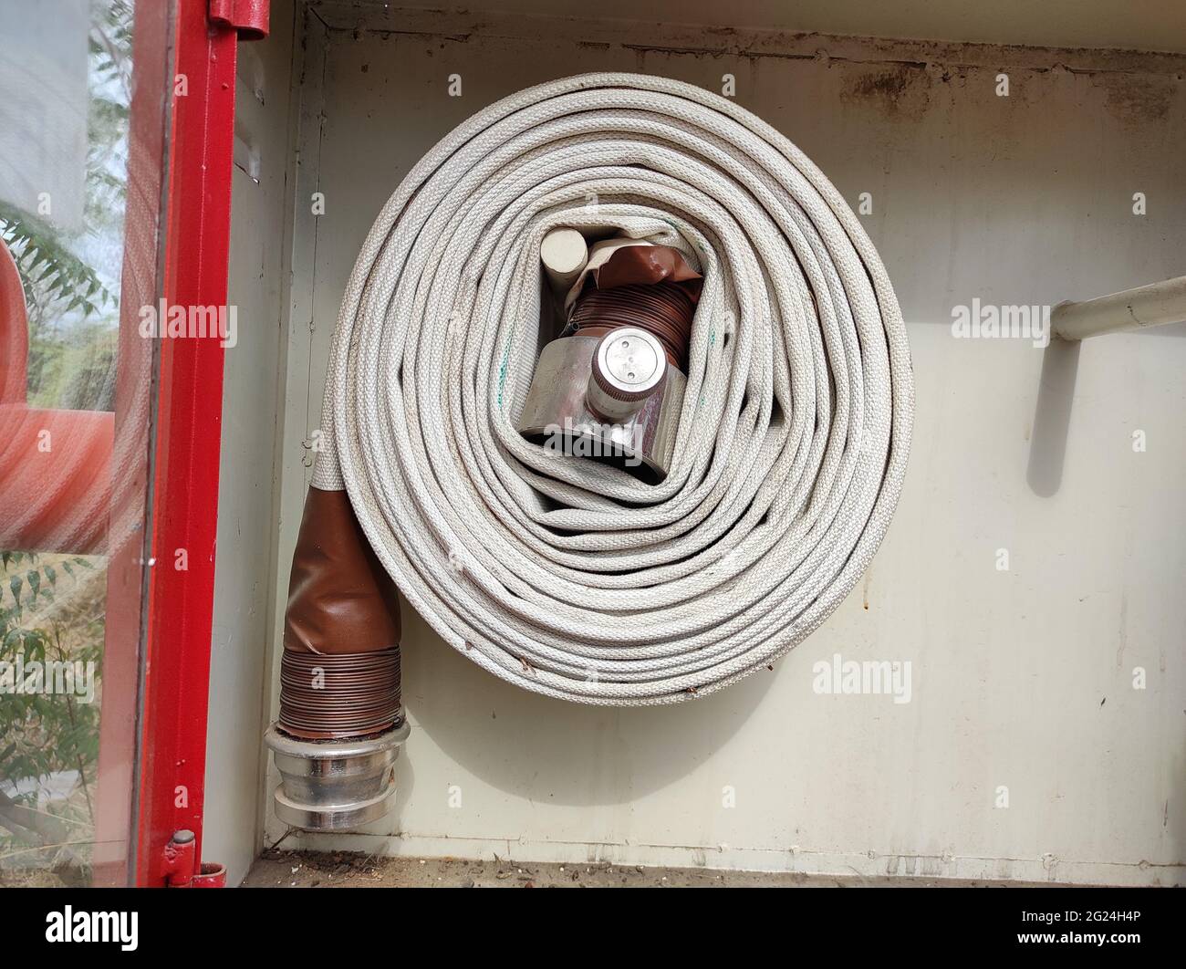 Fire hose on the wall Stock Photo - Alamy