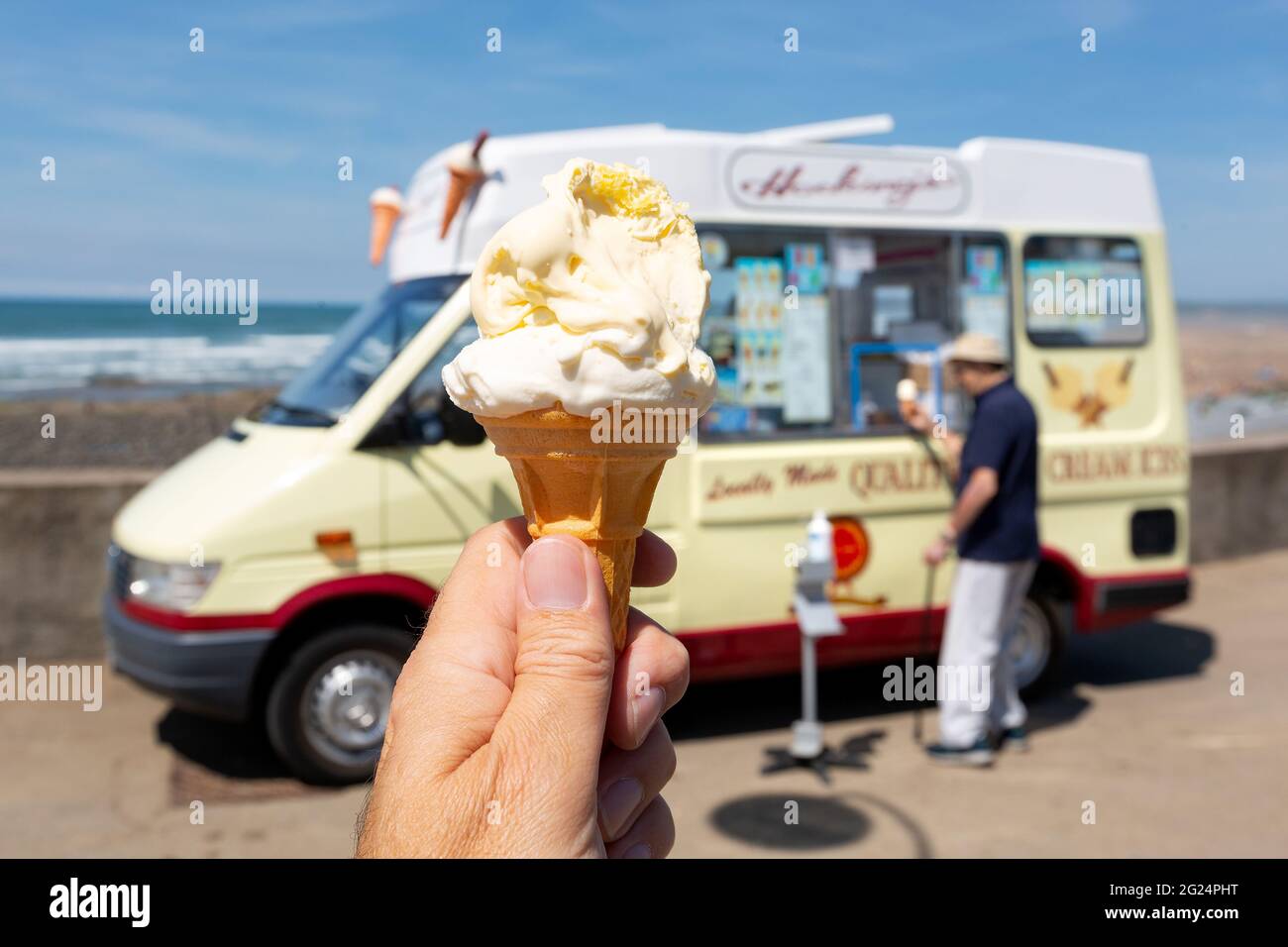 Holidaymakers queue for Hockings ice cream at Westward Ho, Devon Stock