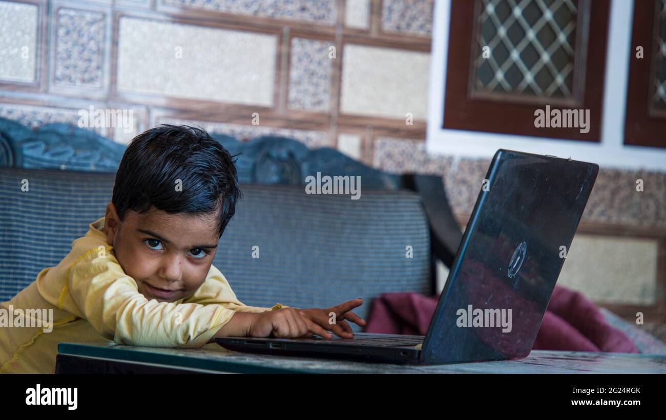 Cute Asian girl working with laptop at home. Teenage girl using laptop at home. Stock Photo