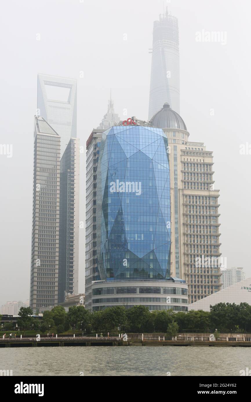 View of Glassed Building on Huangpu River frontage with SWFC and Jin Mao Towers the Pingan Finance Centre and Shanghai Tower in background. Stock Photo