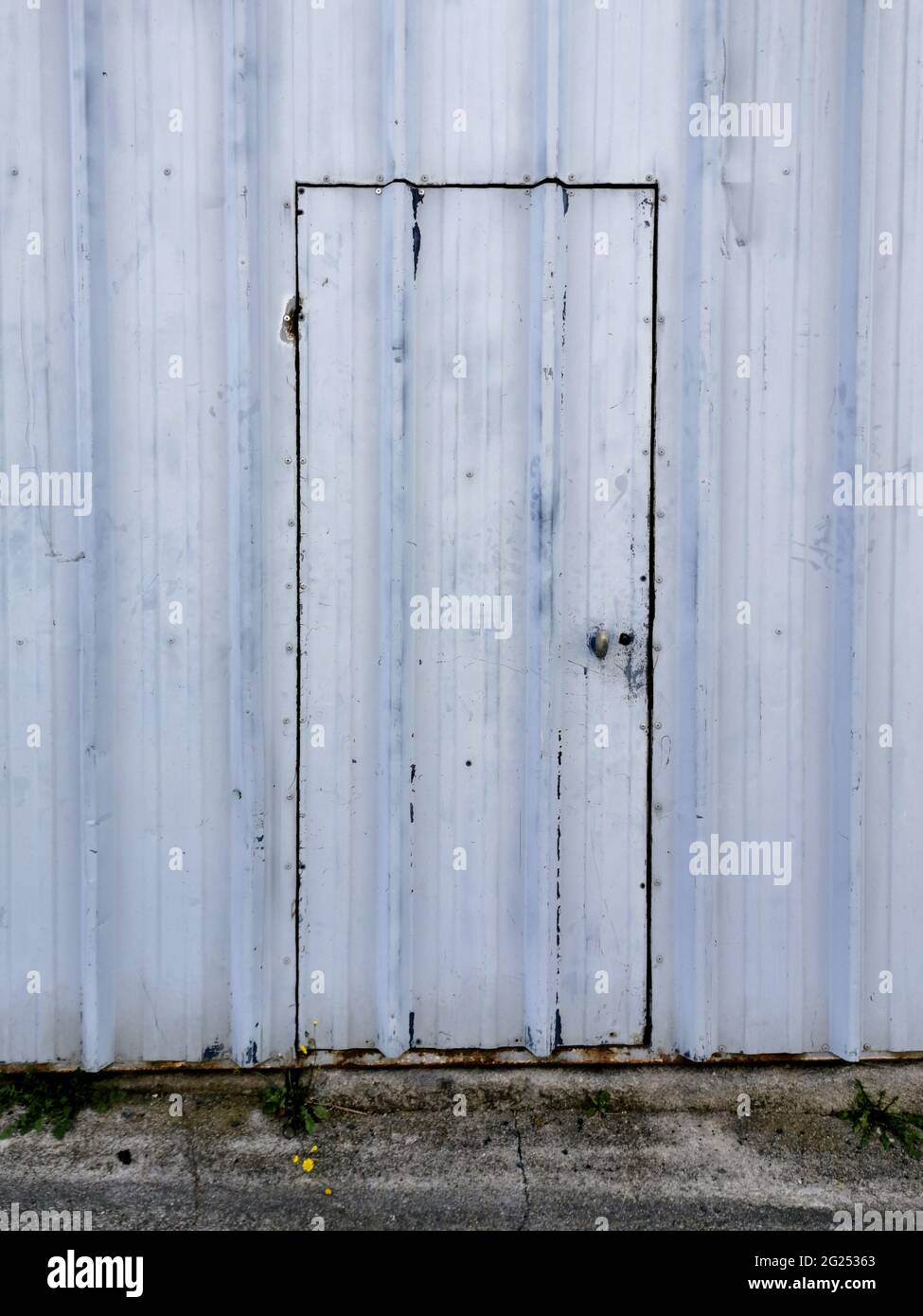 Abandoned warehouse door with empty space wall Stock Photo - Alamy