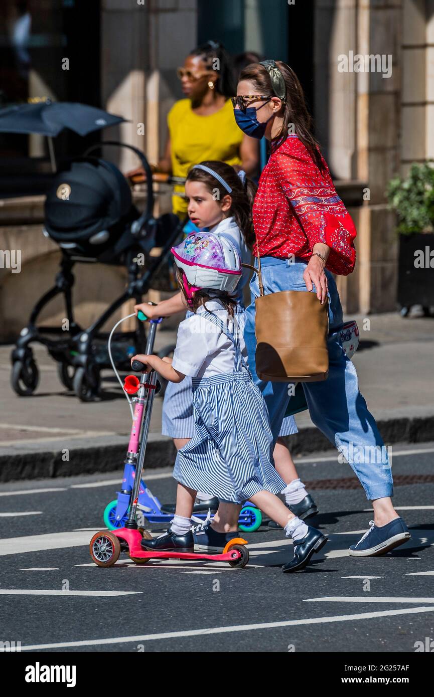 London, UK. 8th June, 2021. The old fashioned amnual powered versions remain popular - Electric scooters (e-scooters) are now available to rent in a small number of London boroughs. This is the only way to legally ride an e-scooter on public roads or in other public places in London. The rental e-scooters is being provided by three different operators: Dott, Lime and TIER. Credit: Guy Bell/Alamy Live News Stock Photo