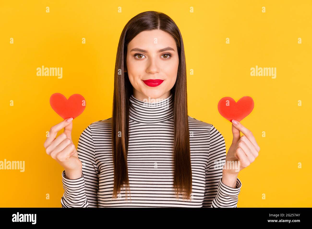 Photo of young attractive girl show small paper red heart cards ...