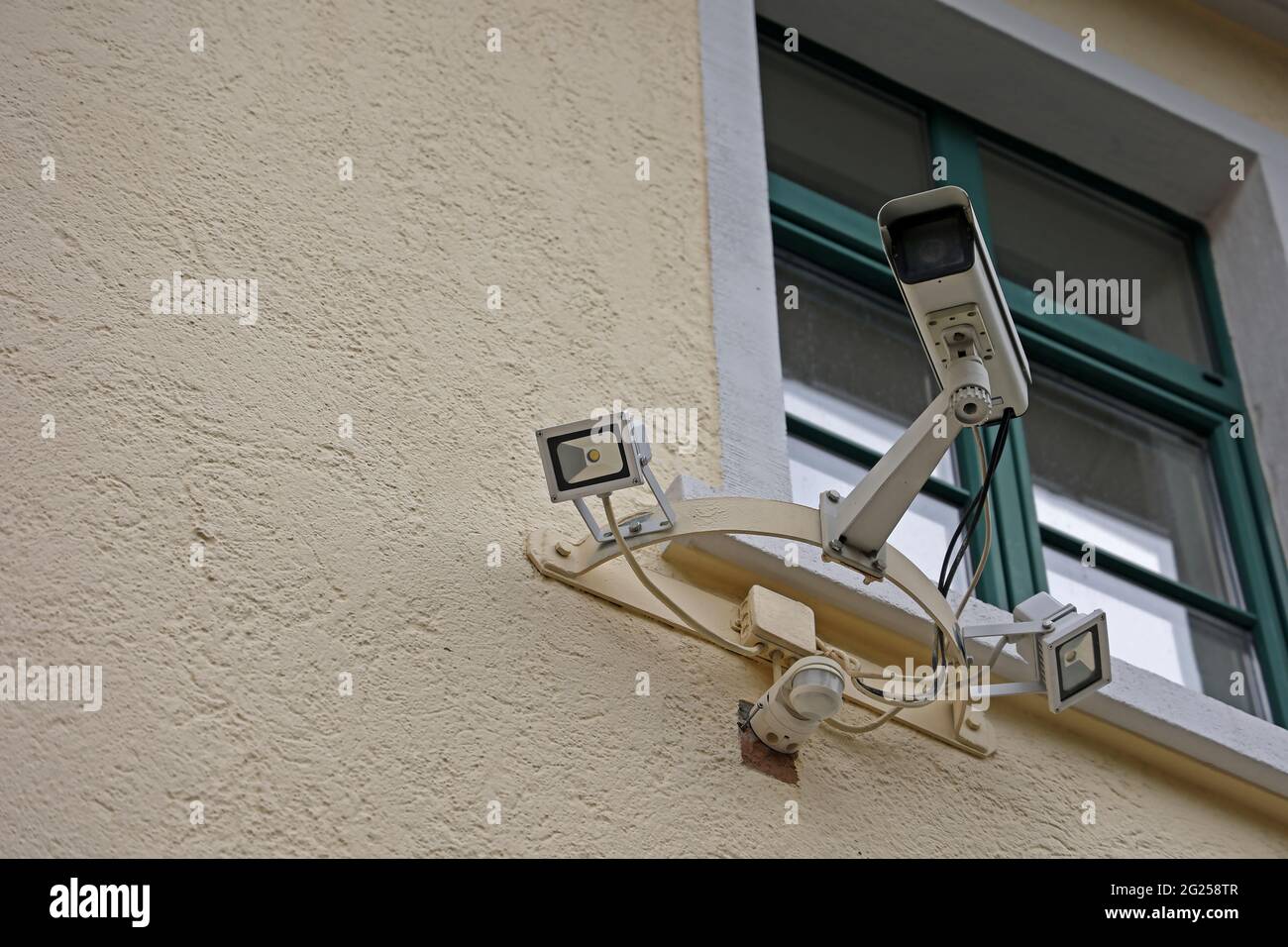 Camera Behind Window Video camera system below a window on the wall of a building Stock ...