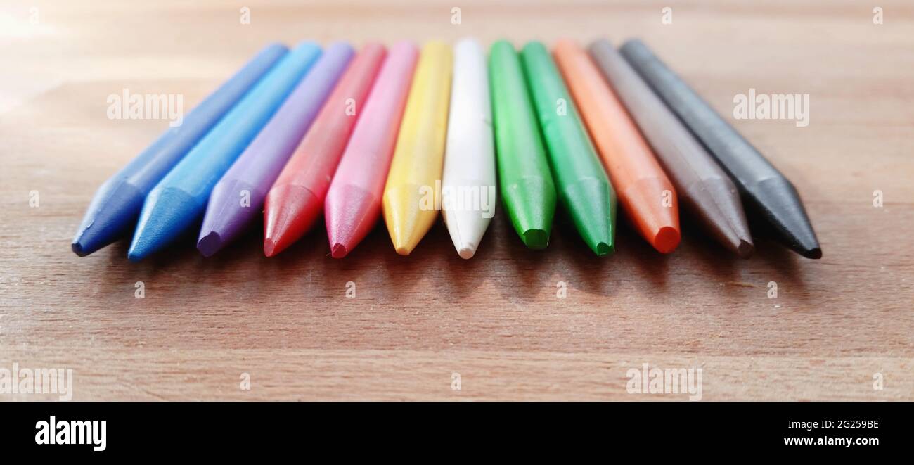 Close-Up of multi coloured crayons on a table Stock Photo