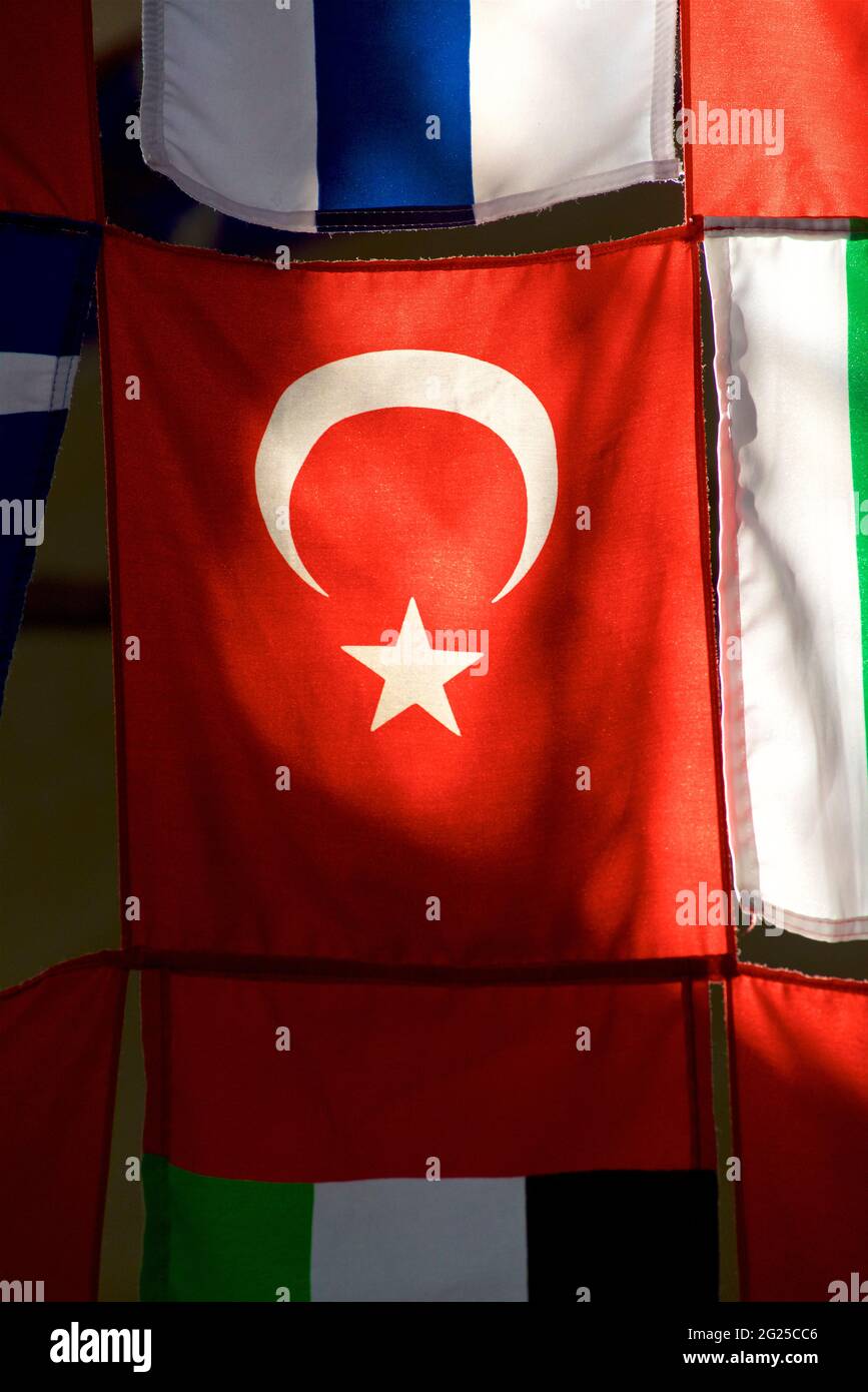 Turkish and other flags, with sunlight penetrating the cloth of the Turkish flag. Istanbul, Turkey Stock Photo