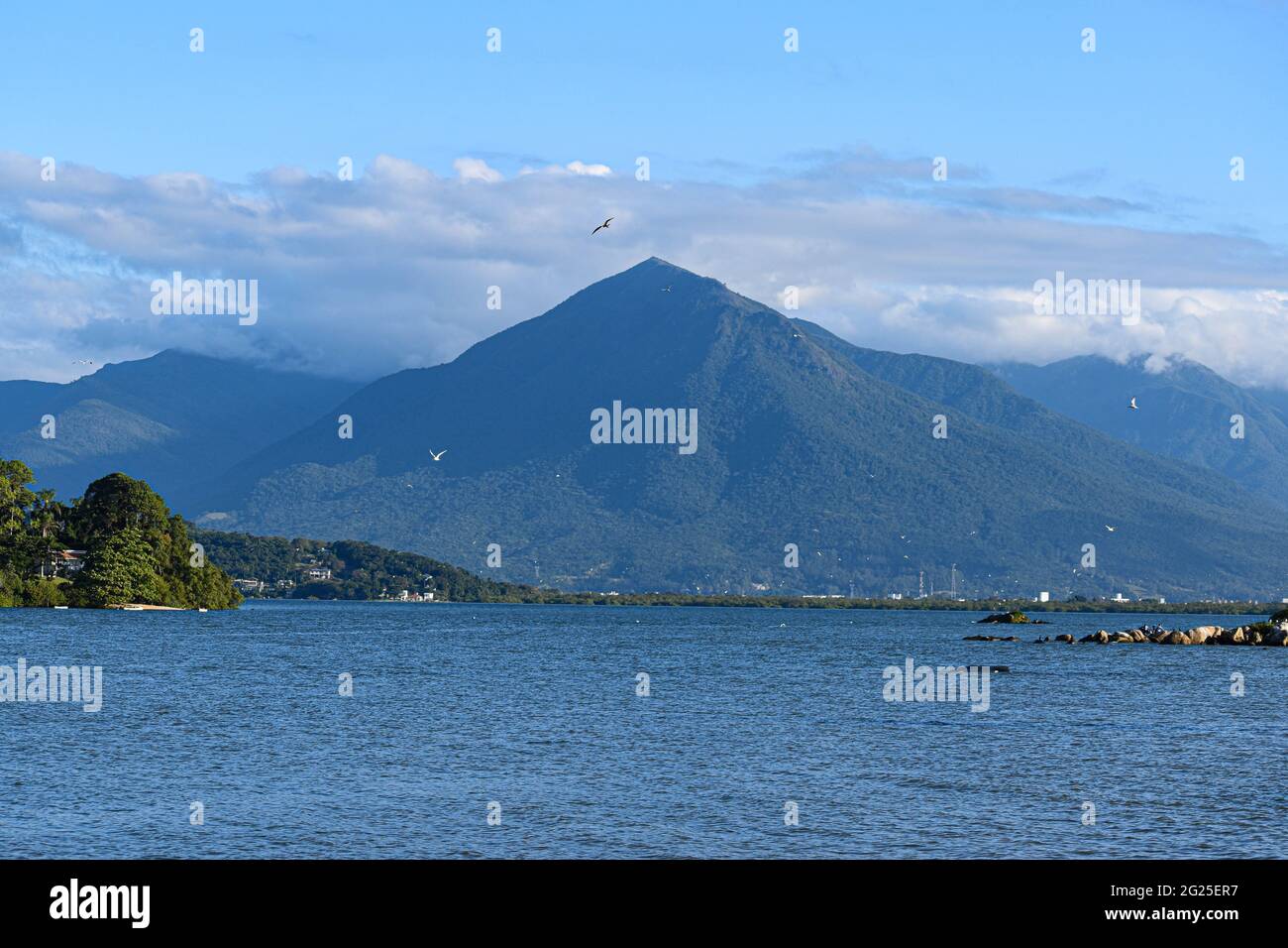 Sea side mountain against a blue sky Stock Photo