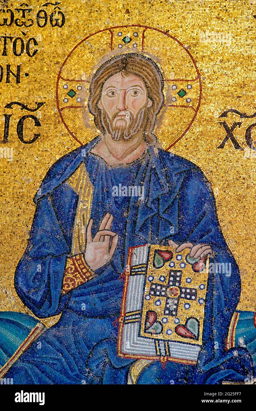 Detail of the Empress Zoe mosaic, Hagia Sophia (Turkish: Ayasofya), Istanbul, Turkey. Christ Pantocrator giving his blessing with the right hand and holding the Bible in his left hand. Clad in a dark blue robe, as is the custom in Byzantine art. Stock Photo