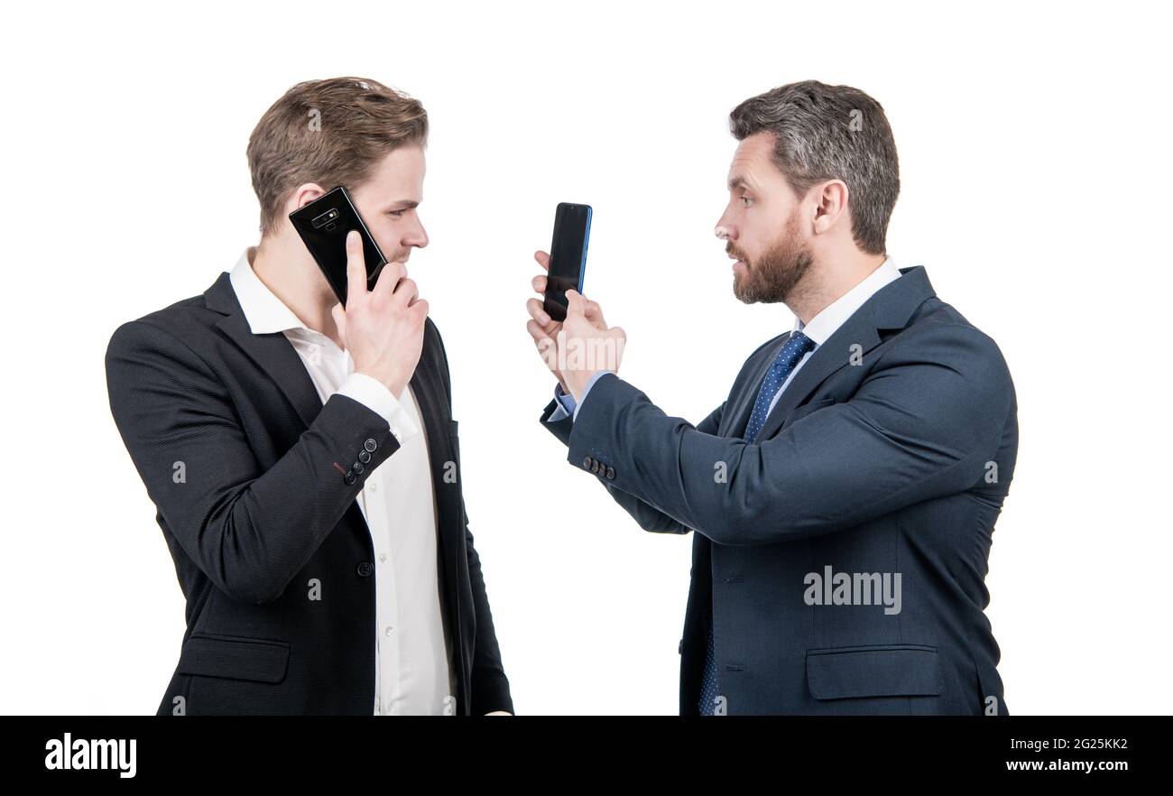 negotiation disagreement of talking man on smartphone and businessman showing phone, argue. Stock Photo