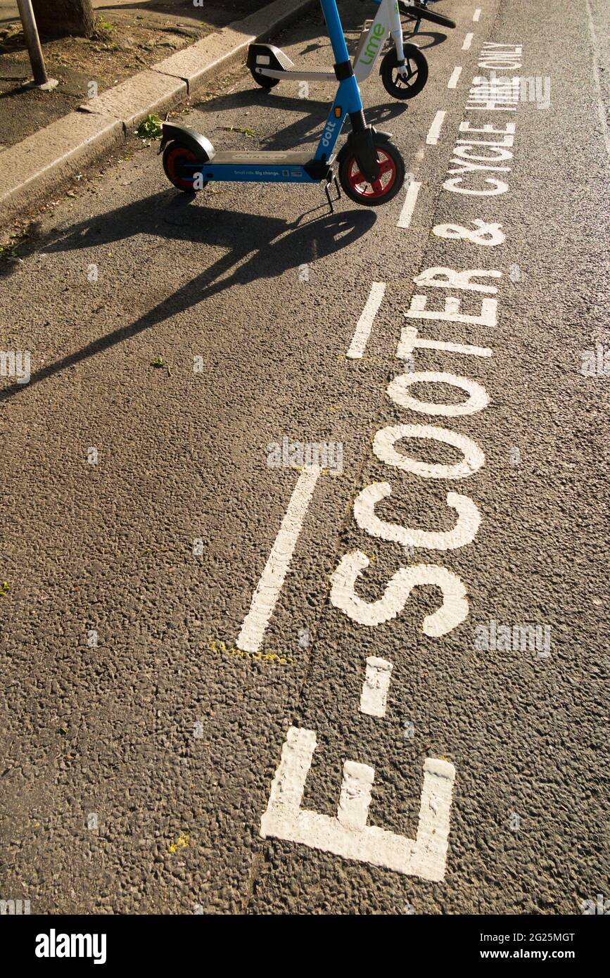 A new parking bay for E scooter / electric scooters for hire on the public road / highway in Twickenham, London. UK. These scooters are legal. (123) Stock Photo