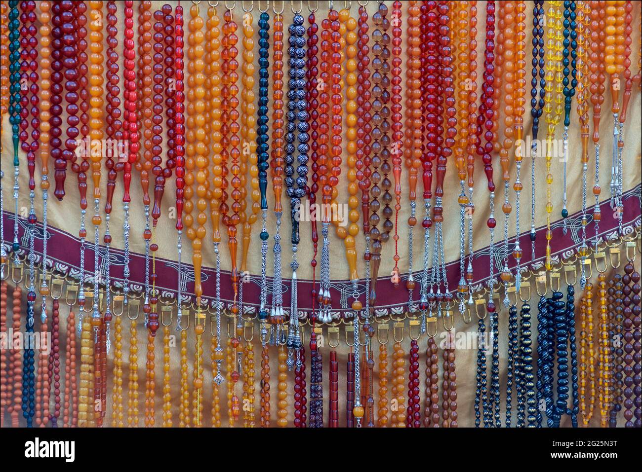 Detail of prayer beads / rosaries hanging up on a market stall for sale, Beyazit Square, Istanbul, Turkey. Stock Photo
