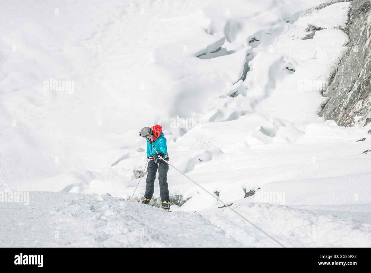 Woman climber abseiling Island Peak's headwall Stock Photo