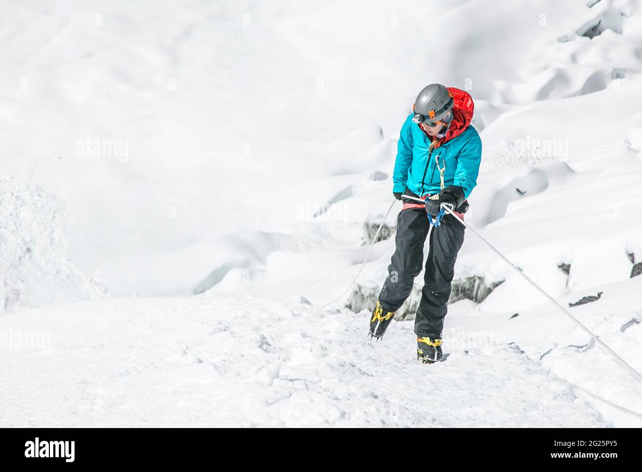 A young woman descends the Island Peak headwall near Everest in Nepal Stock Photo