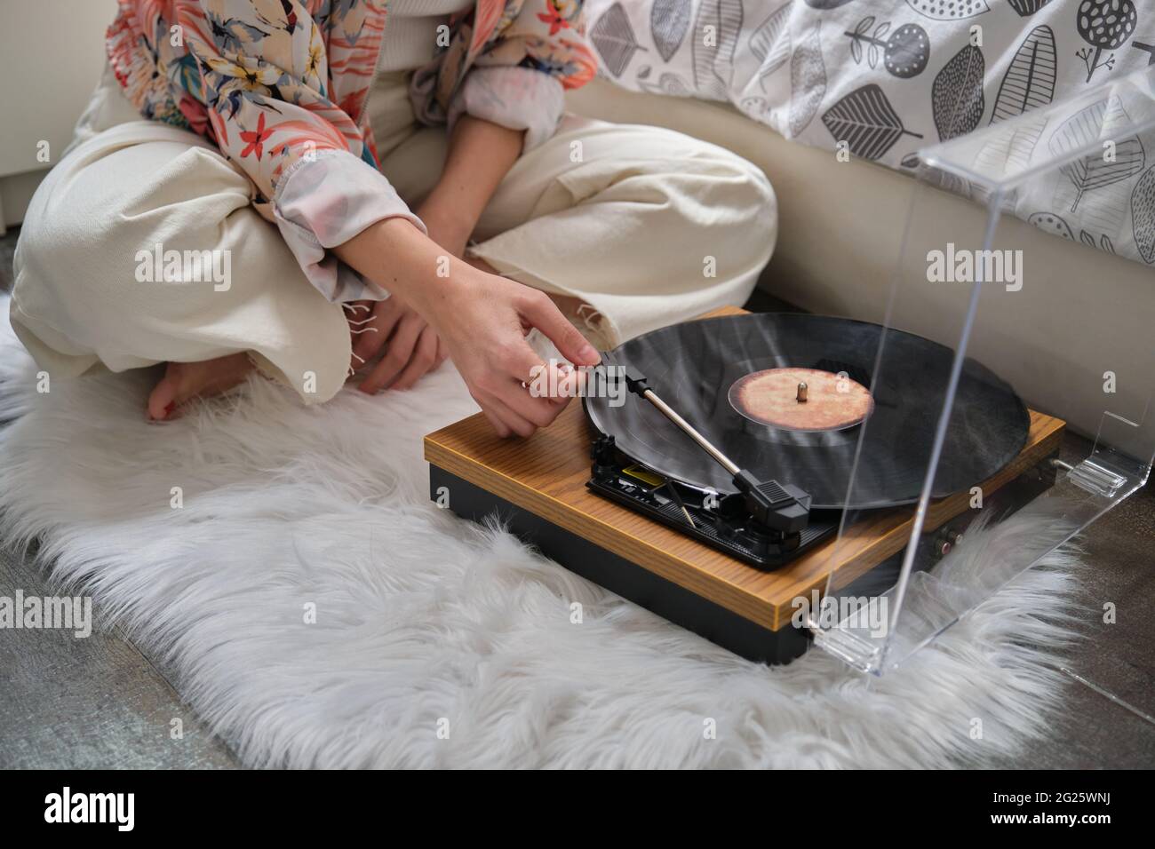 Unrecognizable girl playing a vinyl record on a turntable Stock Photo