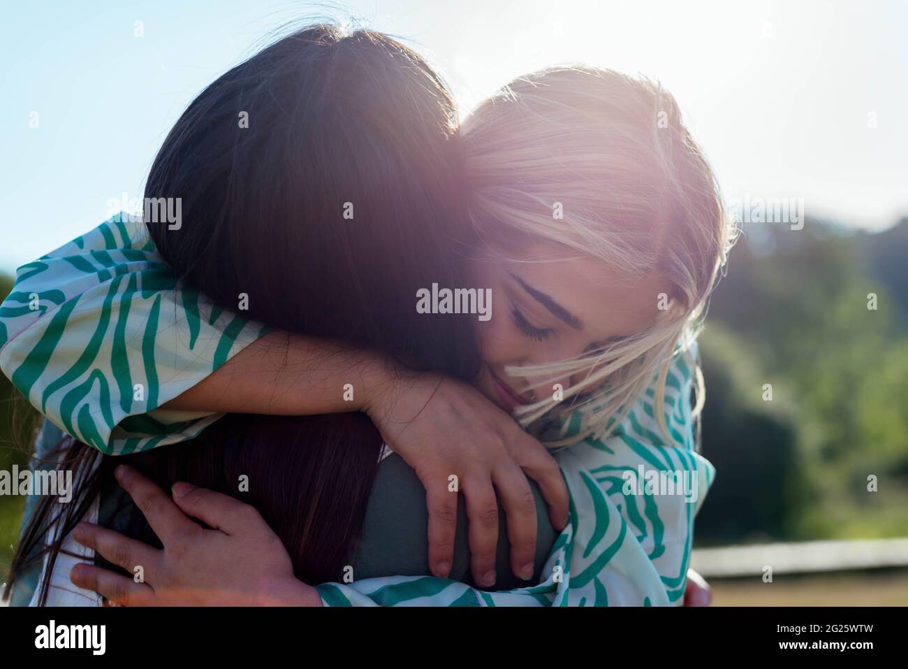 Smiling girls hugging each other Stock Photo