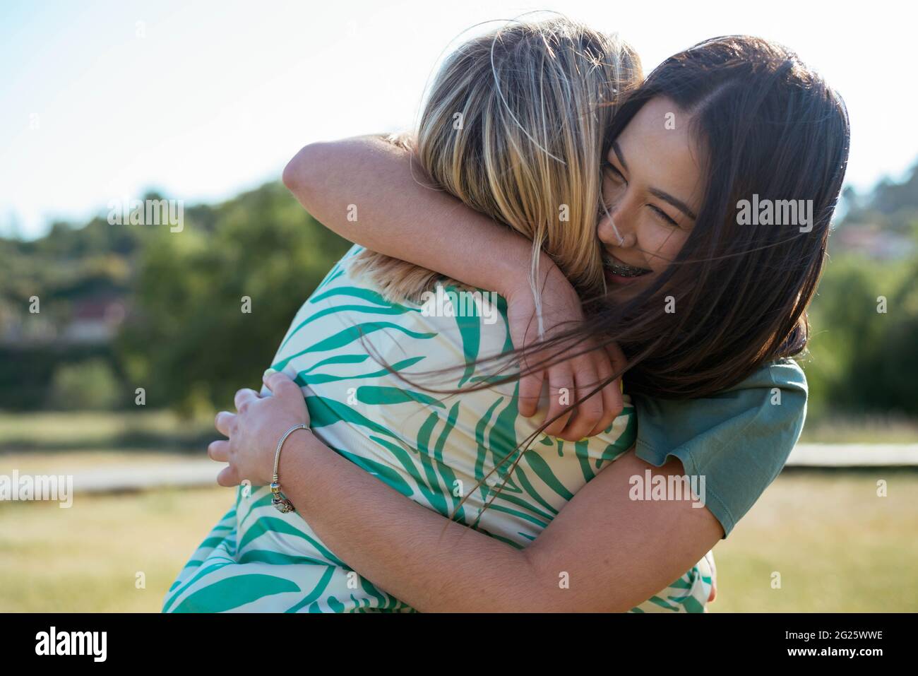 Smiling girls hugging each other Stock Photo