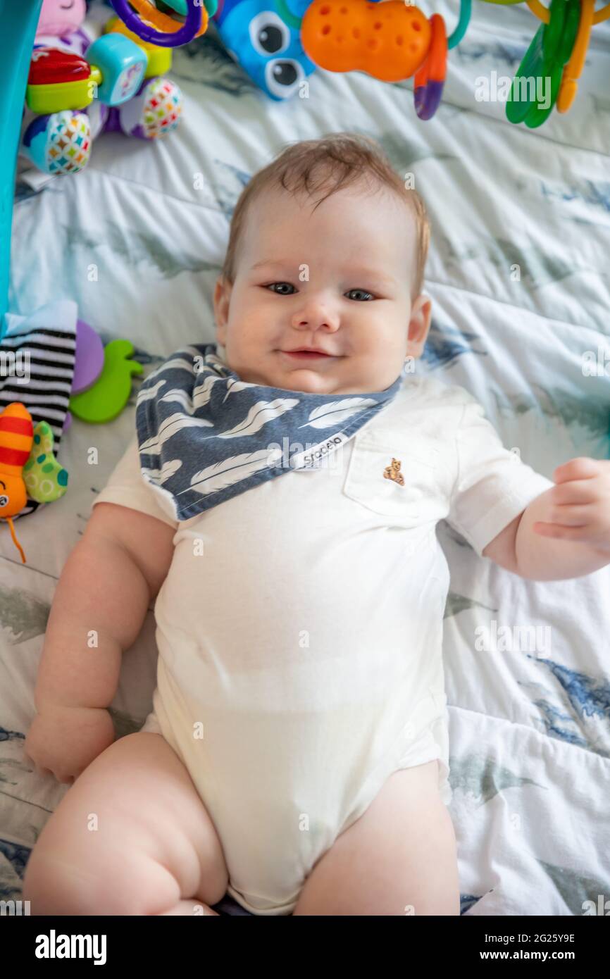 Happy baby boy smiling laying on the floor Stock Photo Alamy