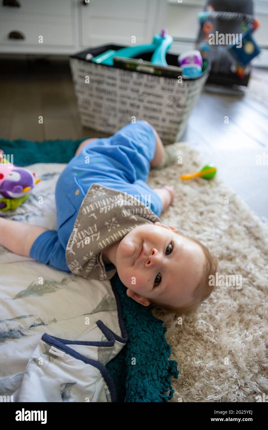 Toddler boy laying on floor and playing hires stock photography and images Alamy