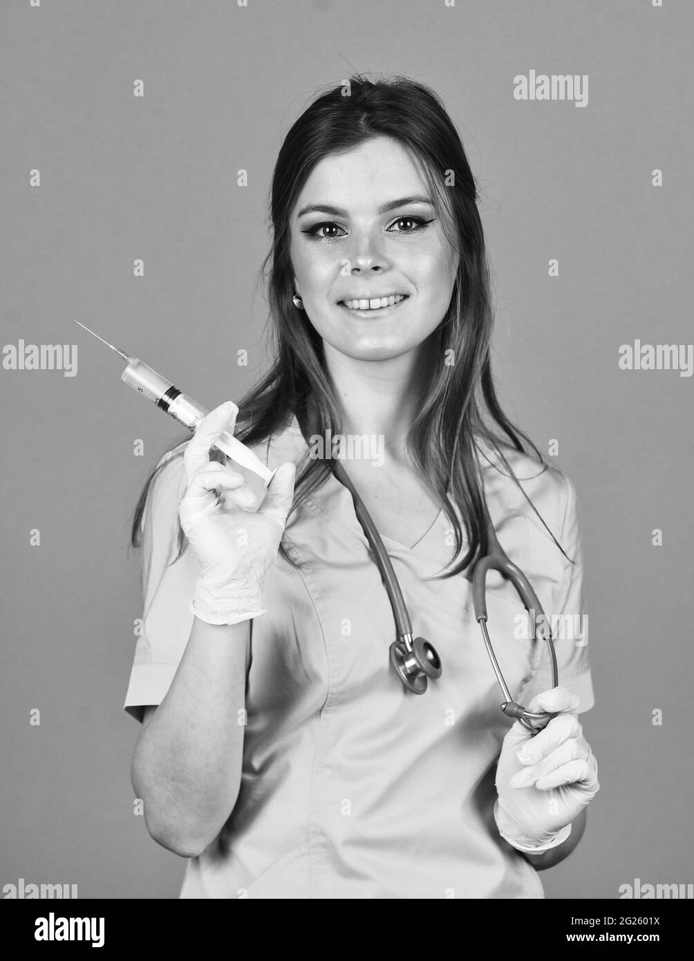 woman doctor use syringe. happy nurse make injection. health worker dials vaccine in syringe. Physician or therapist giving vaccine against virus Stock Photo