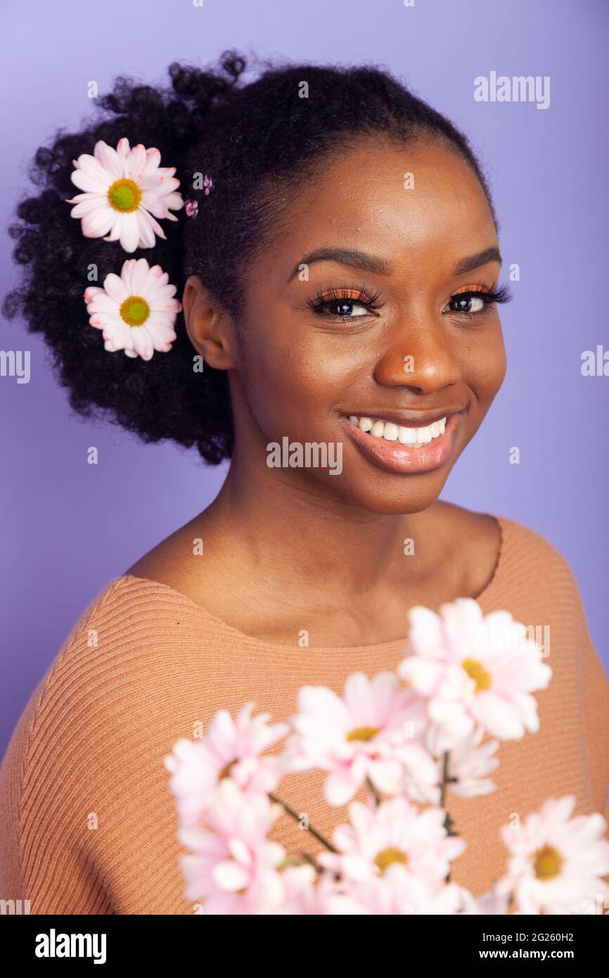 beautiful black woman with flowers in her hair Stock Photo