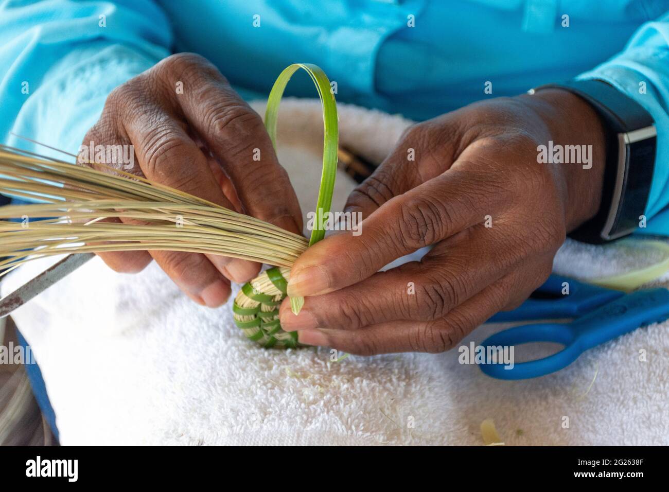 A descendent of slaves, this woman Gullah Geechee master sweetgrass basket weaver creates