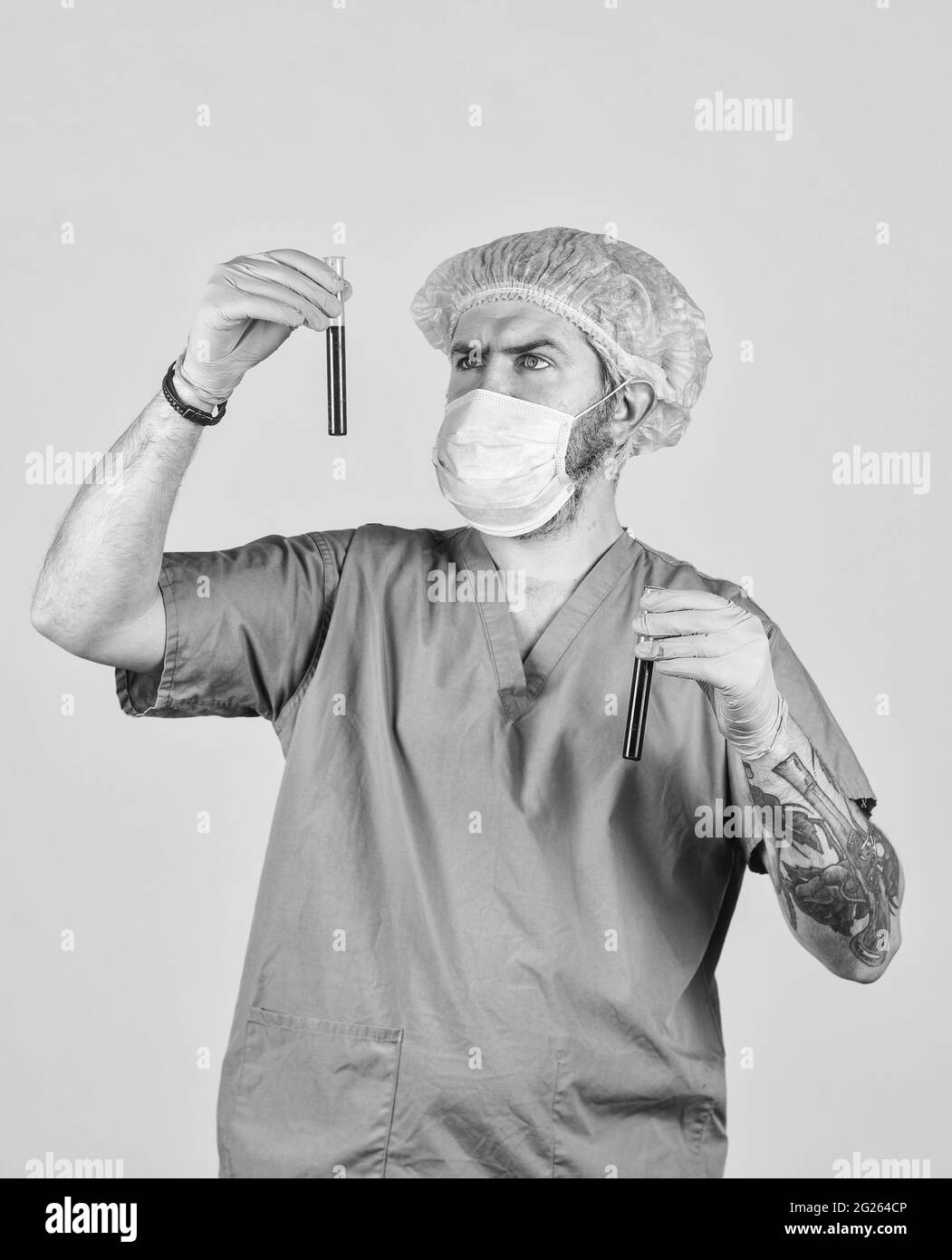 nurse man wear respirator mask hold blood test. symptoms of acute respiratory infection. new virus spreads from China. Pathogen leads to pneumonia Stock Photo