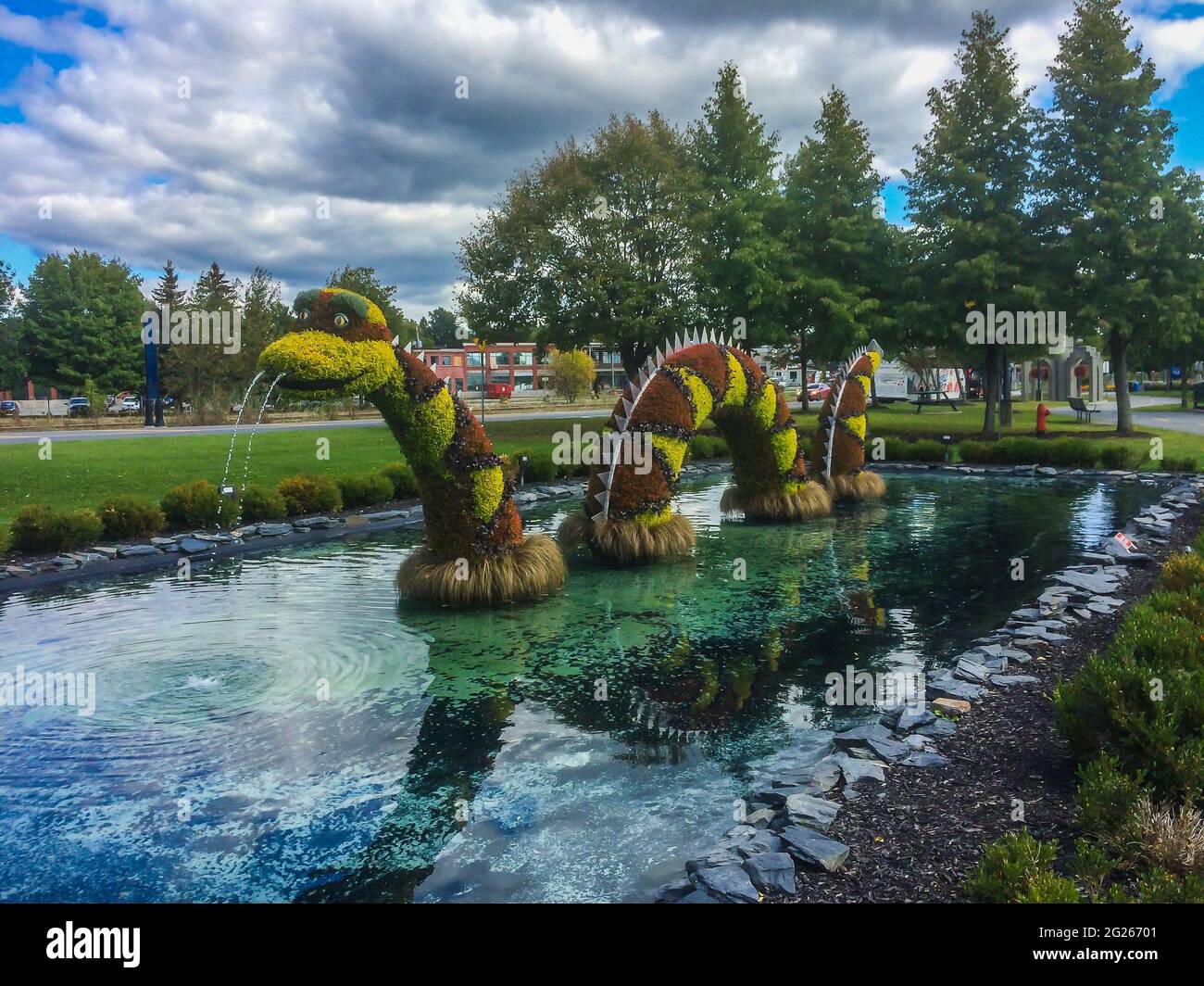 Quebec province, Canada, Sept 2019, colorful animal topiary looking like Memphré a snake/dragon fictional figures in a pond of Magog city Stock Photo