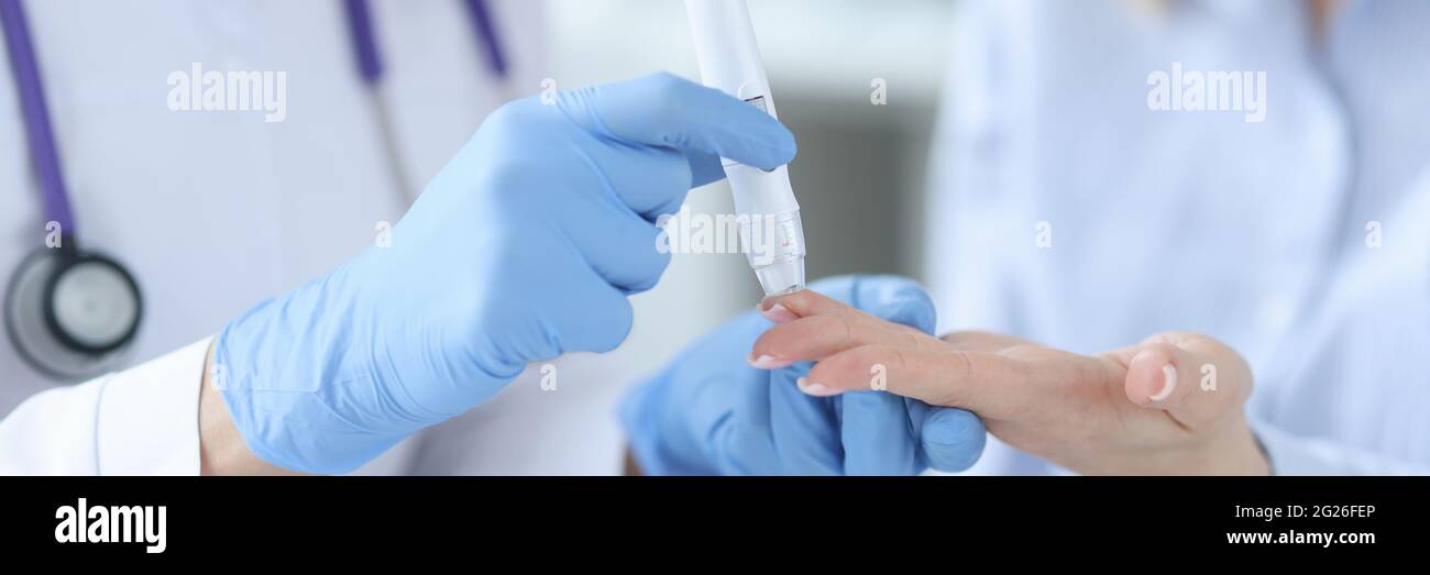 Nurse drawing blood from patient with lancet closeup Stock Photo Alamy