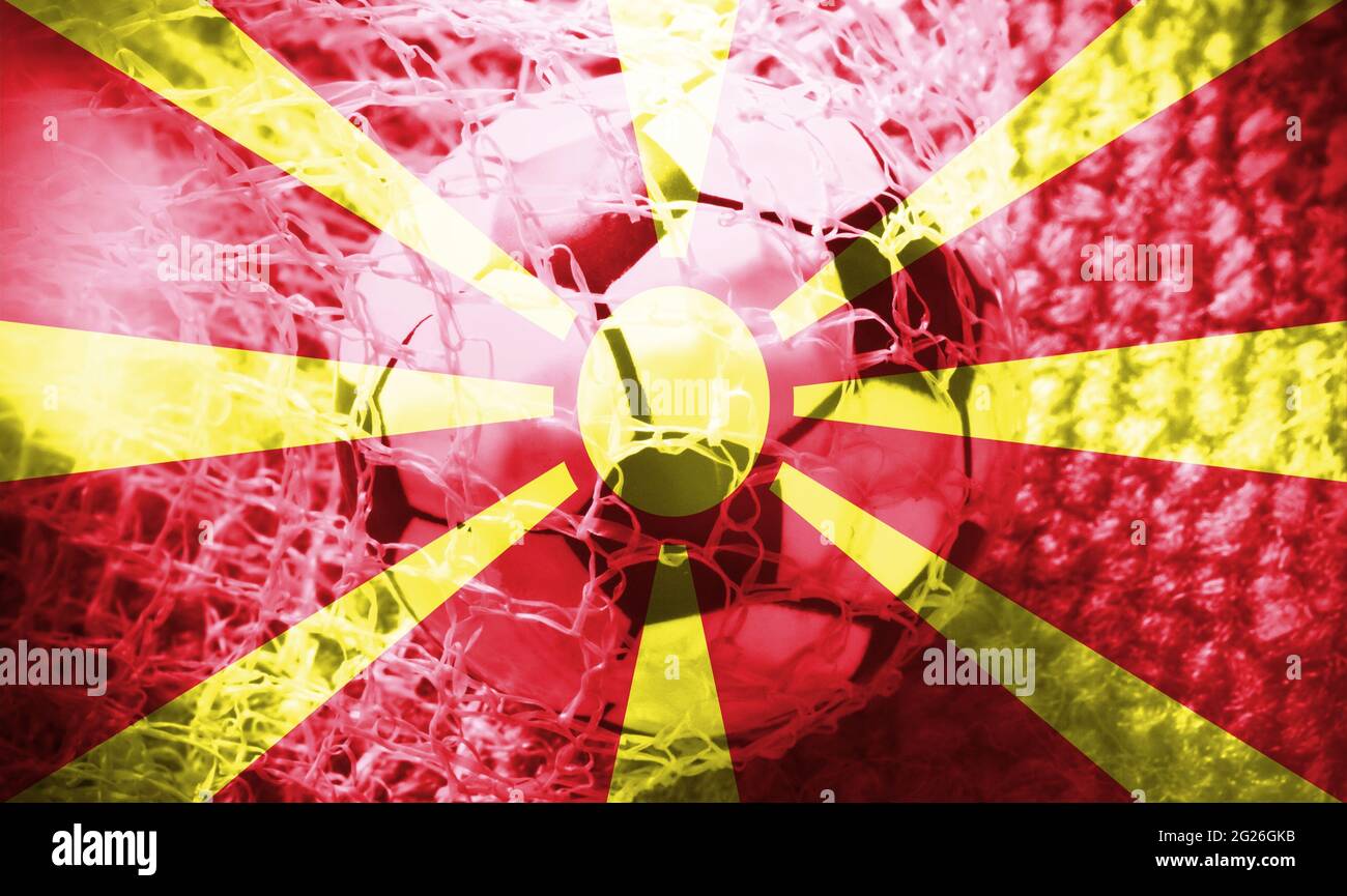Soccer ball inside the net, with the North Macedonian flag as