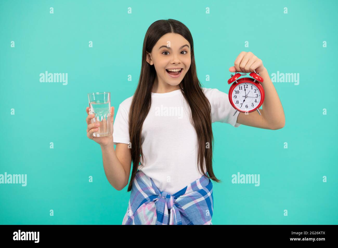 water balance in body. hydration vitality. drinking per day. be hydrated. kid hold glass and clock. Stock Photo