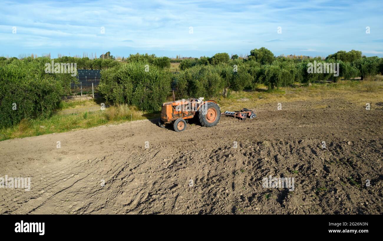 Old tractor with a plow in farmland Stock Photo - Alamy