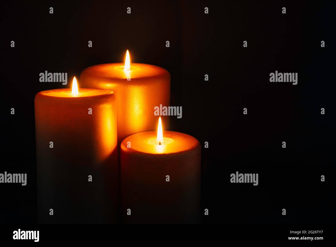 Three golden candles Stock Photo Alamy