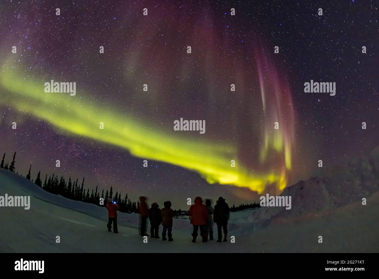 Group of people viewing the northern lights in Churchill, Manitoba, Canada. Stock Photo