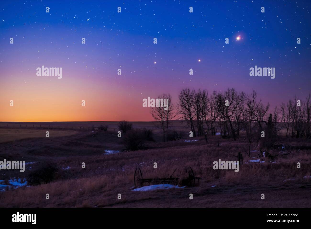 Saturn, Mars and Jupiter in conjunction in the dawn twilight, Alberta, Canada. Stock Photo